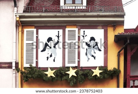 Shutters on the window of an old house in Europe with a picture of angels, christmas concept. My Real Holiday.