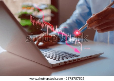 Economic collapse. Businessman using laptop with downward arrow, crisis chats, debt, recession, market collapse, financial problems, inflation, financial crisis economic recession slowing down.