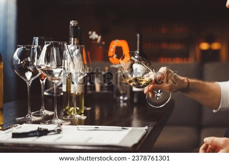 Wine critic, connoisseur tastes, degustates expensive drinks. Royalty-Free Stock Photo #2378761301