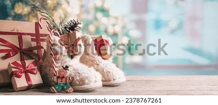 St. Nicholas Day.Boots with sweets and gifts on the floor in the room, St. Nicholas Day greeting card,Christmas Eve,sinterklaas Royalty-Free Stock Photo #2378767261