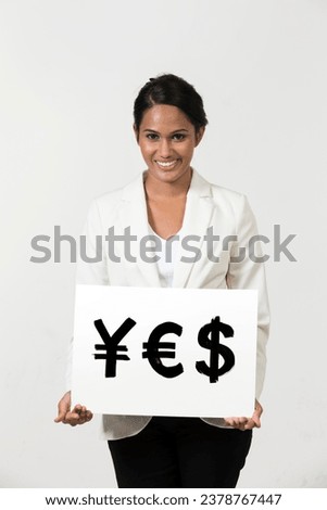 Indian business woman holding currency symbols saying word 'YES'
