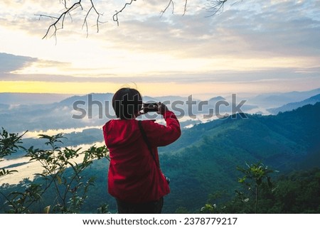 Photographers are capturing landscapes with their cameras towards rivers, mountains, clouds, and seas of mist.
