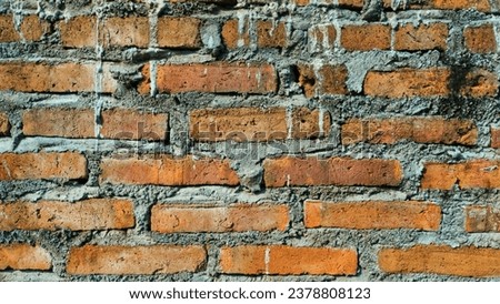 A weathered brick from a crumbling wall, captured in a landscape orientation. This image portrays the raw beauty of aged construction materials, showcasing the passage of time.