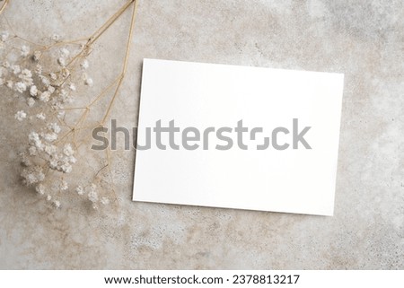 Wedding invitation card mockup with dry gypsophila flowers on beige background, copy space for card design Royalty-Free Stock Photo #2378813217