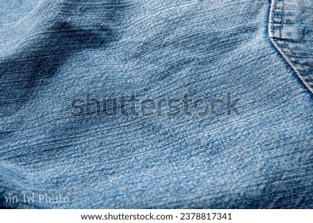 Jeans Fabric Pattern Background: Jeans Background Image Creating a background picture with a fabric pattern for jeans can add a unique and stylish touch to your design. Here's Royalty-Free Stock Photo #2378817341