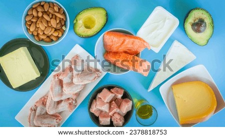 paleo diet concept on blue background chicken meat fish veal nuts avocado cheeses and butter Royalty-Free Stock Photo #2378818753