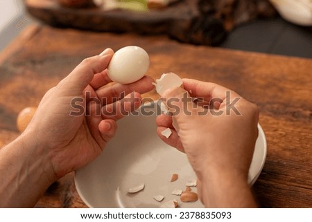 male hands peel boiled eggs