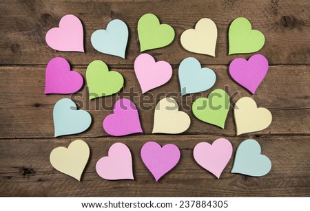 Collection on many colorful hearts on wooden background for love concepts.