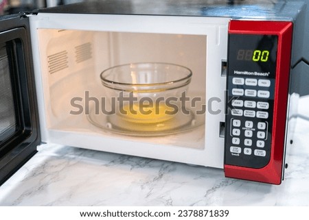 Melting stick of unsalted butter in a microwave. Royalty-Free Stock Photo #2378871839