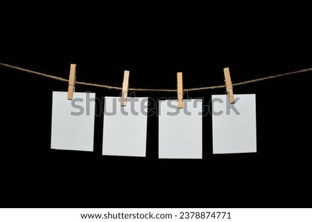 black background with a rope and clothespins holding papers Royalty-Free Stock Photo #2378874771