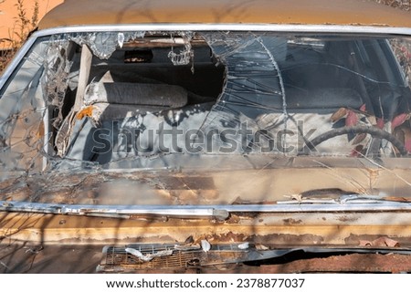 When I first saw this car, my eyes looked at the abstract image possibilities. Then I saw what had really happened. Car accident. Passenger went through windshield. Wear your seatbelt. Be safe. Royalty-Free Stock Photo #2378877037