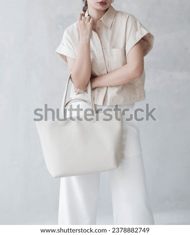 Pose with a luxurious bag that is suitable for formal or casual events Royalty-Free Stock Photo #2378882749