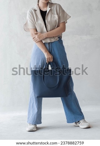 Pose with a luxurious bag that is suitable for formal or casual events Royalty-Free Stock Photo #2378882759