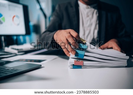 Work from Home, Businessman hands working in Stacks of paper files for searching information on work desk home office