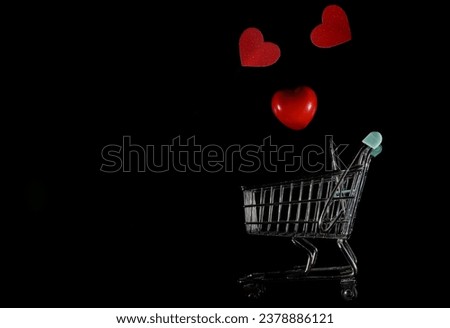 Collection of shiny red hearts in a shopping cart