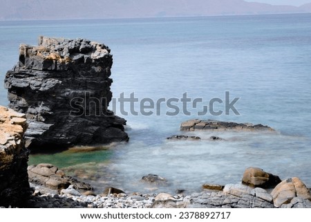 Beautiful Sea Turquoise Landscape Of A Beach With Rocks  - Long Exposure Slow Shutter Speed Effect
