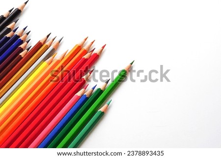 Top view of colored pencils or pastel on white background. Learning, study and presentation concept.