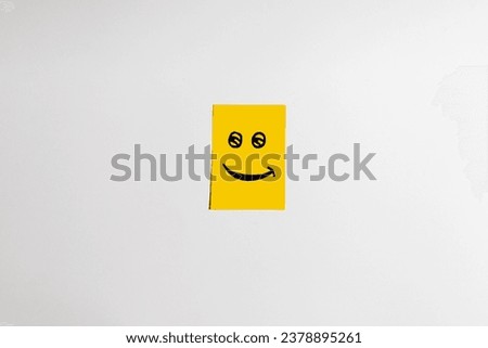 Smile face on yellow short note paper white background