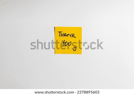 Yellow sticky note with text "Thank you!". with happy smiley face Royalty-Free Stock Photo #2378895603