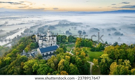 Hluboká nad Vltavou state castle located in the town of the same name in South Bohemia. Captured in autumn at sunrise with morning fog