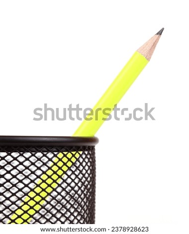 yellow pencil in black penholder isolated on white background Royalty-Free Stock Photo #2378928623