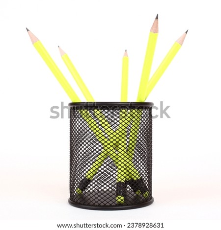 yellow pencils in black penholder isolated on white background Royalty-Free Stock Photo #2378928631