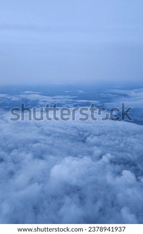 Scenery above the clouds viewed from airplane window