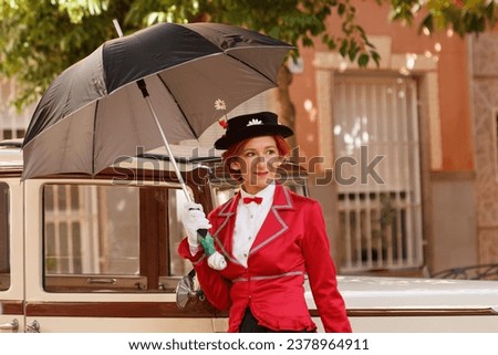 Woman dressed as Mary Poppins leaning on retro car at the modernist fair Novelda 2023 Royalty-Free Stock Photo #2378964911