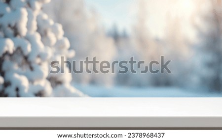 Winter xmas background with empty space on table top in front. Christmas horizontal blank scene. Wooden table top in front, blurred сhristmas tree in the snow. Snowy scene 