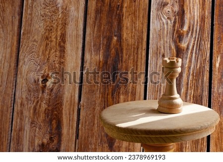 chess piece rook on a wooden board.Rook in chess game