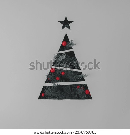 Christmas creative concept. Christmas tree with red balls on gray background. 