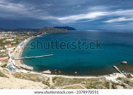 Crimea - May 2021. A line of beaches in the city of Sudak. View from the Genoese fortress on the Sudak Bay. Royalty-Free Stock Photo #2378970551