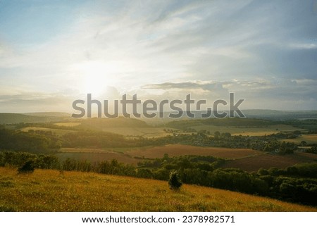 Looking at a sunset on countryside and farm fields