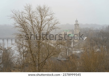 Fog over the town. Photography of Staritsky Assumption Monastery and Bridge across Volga river. Top view, View from above. Rainy autum day in russian countryside in Tver oblast, region.