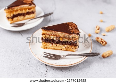 Snickers cake with caramel, peanuts and buttercream. Royalty-Free Stock Photo #2379012455