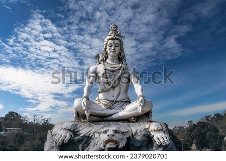 Lord Shiva statue on the banks of the sacred Ganges River in Rishikesh, India.  Royalty-Free Stock Photo #2379020701