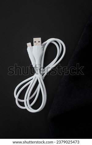 Unoriginal, fake USB-A and Lightning cable, white color on dark background