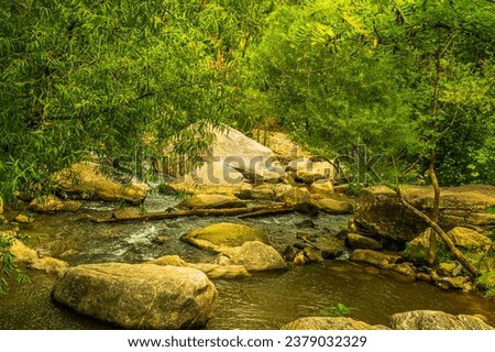 River Trail along the Rocky Broad River in downtown Chimney Rock North Carolina Royalty-Free Stock Photo #2379032329