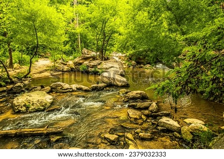 River Trail along the Rocky Broad River in downtown Chimney Rock North Carolina Royalty-Free Stock Photo #2379032333