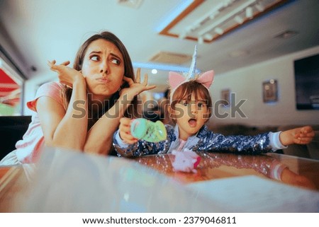 
Little Girl Screaming while her Mom Covers her Ears. Naughty kid misbehaving in a public place acting out 
 Royalty-Free Stock Photo #2379046811