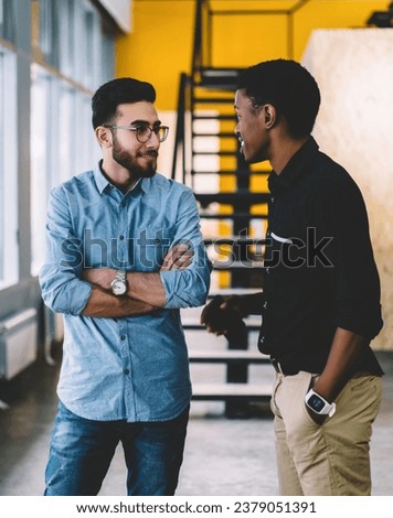 men at friendly conversation in coworking Royalty-Free Stock Photo #2379051391