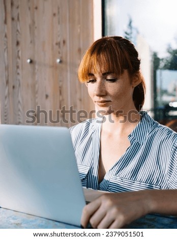 young female blogger checking mail and news from social media create content of freelance