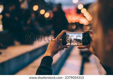  millennial woman taking images via camera