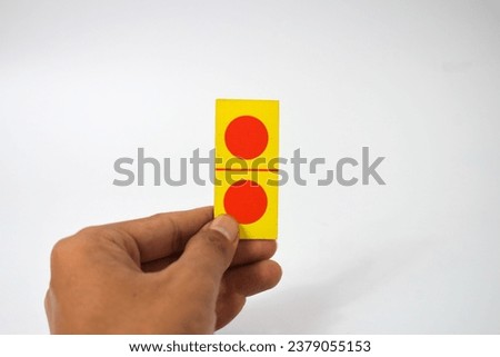 hand hold dominoes playing cards isolated white background, yellow red dominoes cards