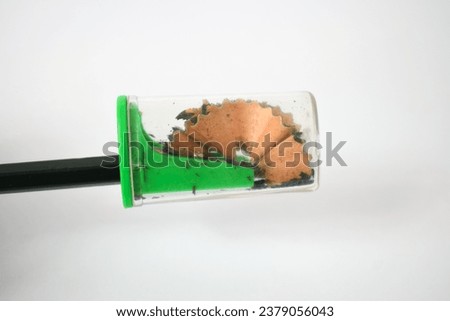 green pencil sharpener and dark green pencils on white background Royalty-Free Stock Photo #2379056043