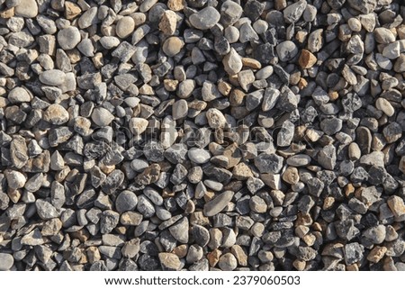 Smooth round pebbles texture background. Pebble sea beach close-up, dark wet pebbles and gray dry pebbles. High quality photo