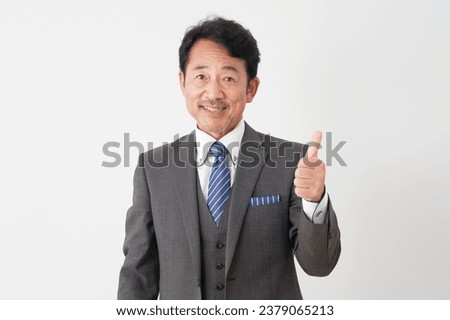 Asian middle aged businessman thumbs up gesture in white background