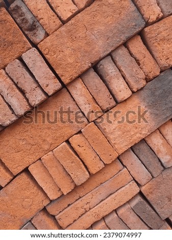 Portrait abstract picture of piles of brown bricks, ready to use. Shot at diagonal angle.