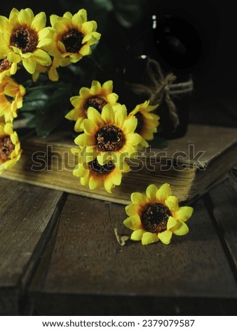 Book and the yellow flower are decorated table in my room