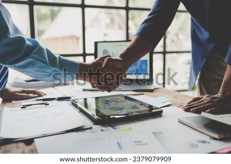 Young businessman and financial representative shaking hands after a budget deal for business expansion and investment in a village construction project real estate financial concept. Royalty-Free Stock Photo #2379079909